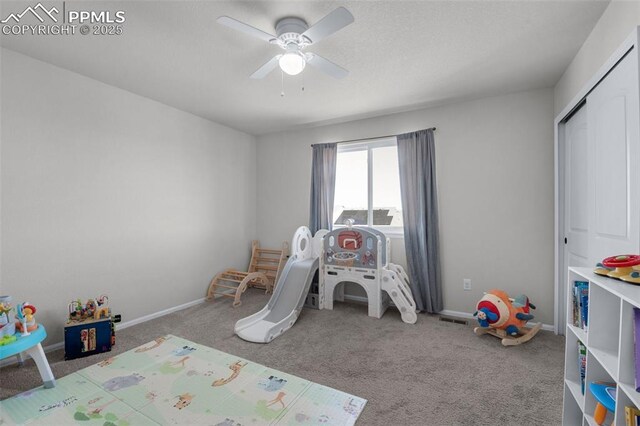 playroom with ceiling fan, carpet flooring, and baseboards