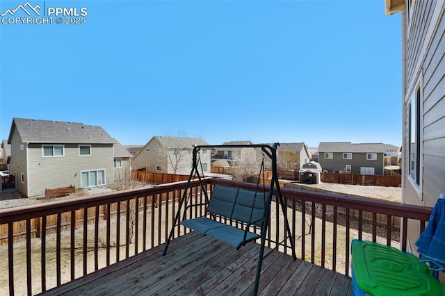 wooden terrace with a residential view and fence