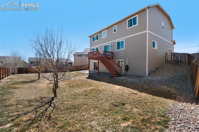 rear view of property with a yard, a fenced backyard, stairs, and a wooden deck