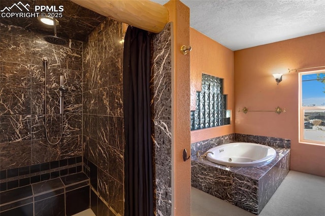 full bathroom featuring a whirlpool tub, a tile shower, and a textured ceiling