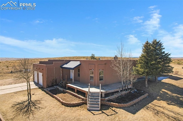 exterior space with a garage, concrete driveway, and stucco siding