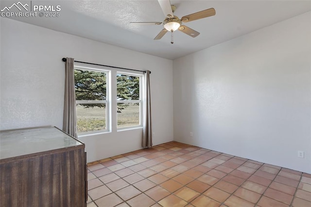 unfurnished room with ceiling fan and light tile patterned floors