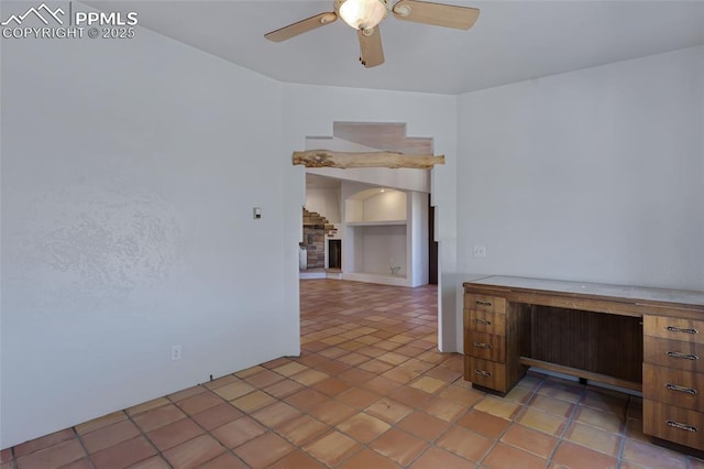 unfurnished room with light tile patterned floors, ceiling fan, and a fireplace