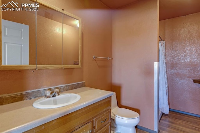 full bathroom with toilet, wood finished floors, a shower with shower curtain, and vanity