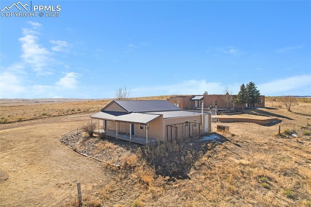 view of front of home with an outbuilding and metal roof