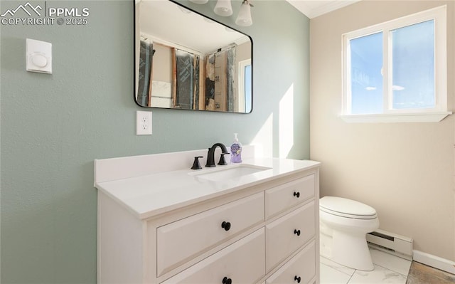 bathroom with marble finish floor, toilet, a baseboard heating unit, vanity, and baseboards