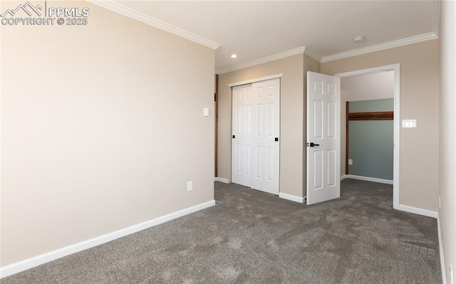 unfurnished bedroom with baseboards, dark carpet, a closet, and ornamental molding