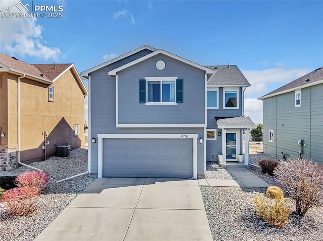 traditional-style house featuring an attached garage, cooling unit, and concrete driveway