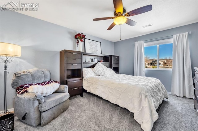 bedroom with baseboards, carpet, visible vents, and a ceiling fan