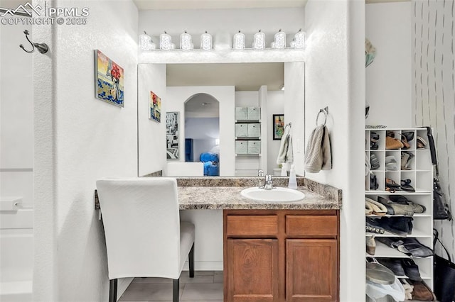 ensuite bathroom featuring connected bathroom and vanity