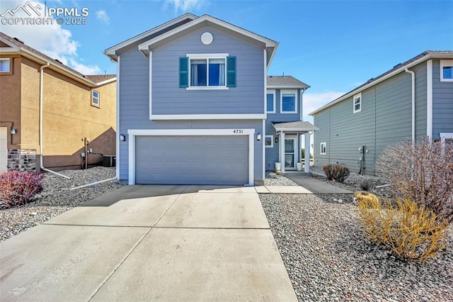 traditional-style house with a garage and concrete driveway