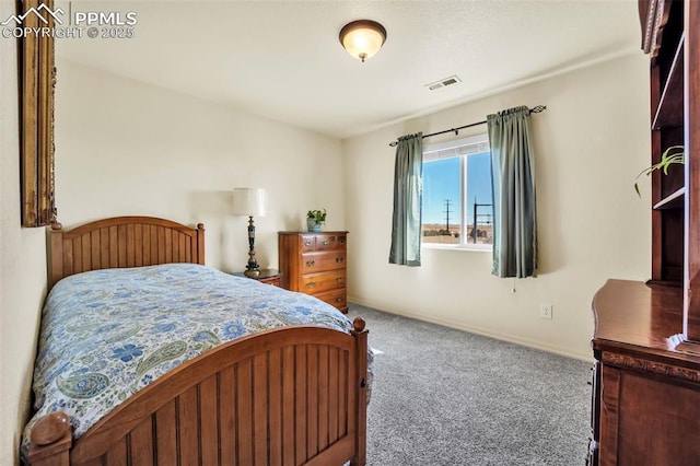 bedroom with carpet floors, visible vents, and baseboards