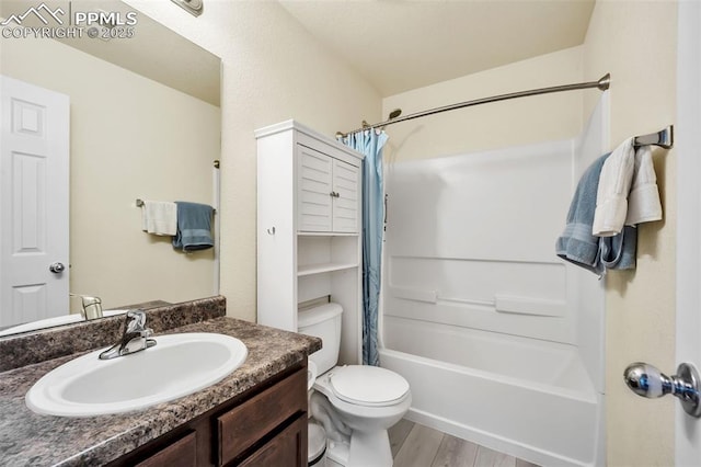 bathroom with shower / bath combination with curtain, vanity, toilet, and wood finished floors