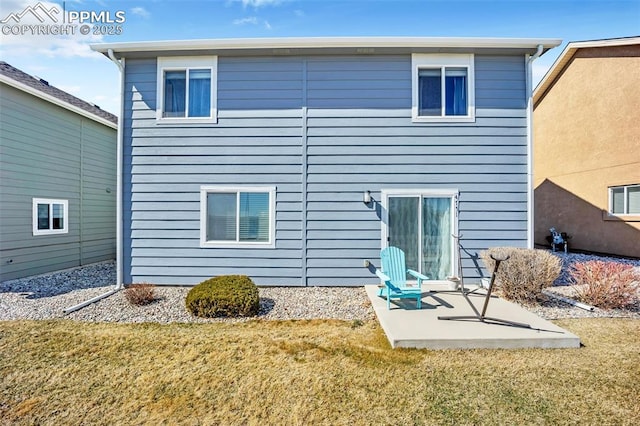 rear view of house with a yard and a patio