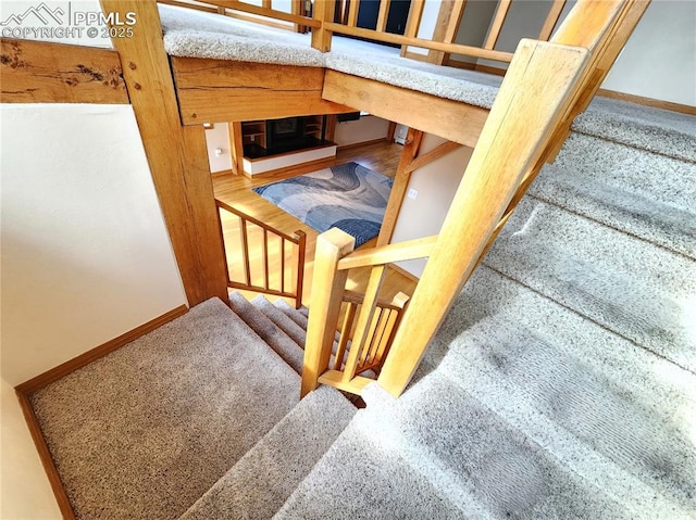 stairs featuring baseboards and wood finished floors