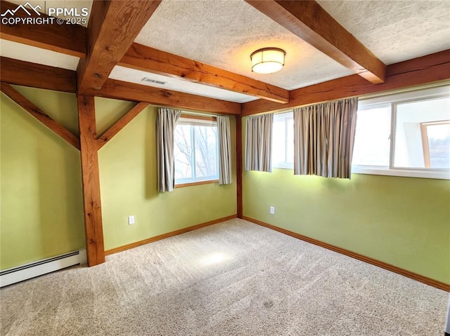 carpeted spare room featuring beam ceiling, baseboards, baseboard heating, and a textured ceiling