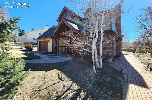 view of front of home featuring stone siding and an attached garage