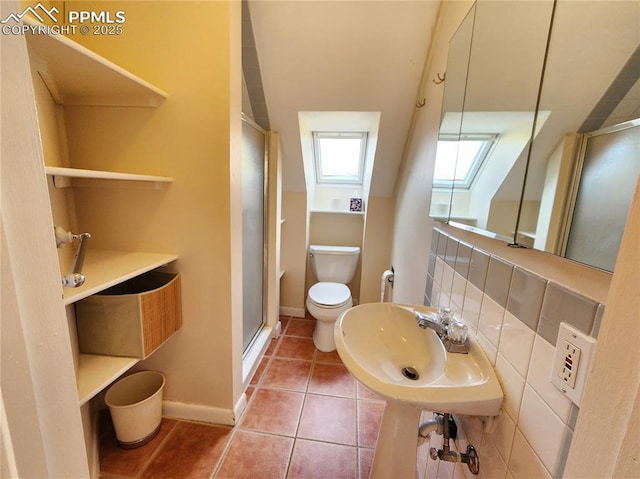 bathroom with tile patterned flooring, a stall shower, toilet, and baseboards