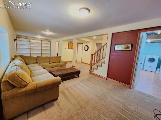 living area featuring washer / dryer, baseboards, stairs, and carpet