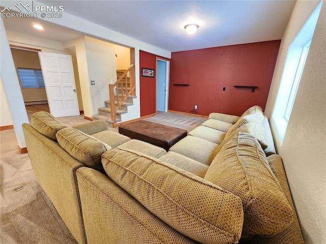 living room with stairway, a baseboard heating unit, baseboards, and carpet floors