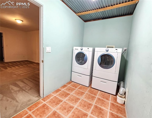 washroom with light tile patterned floors, light colored carpet, independent washer and dryer, and laundry area