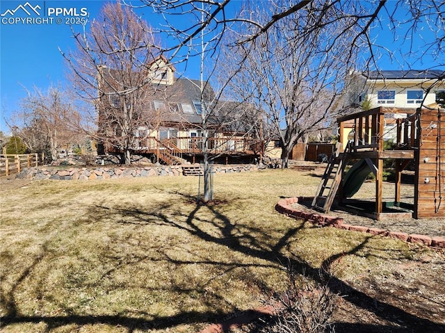 view of yard featuring a playground and fence