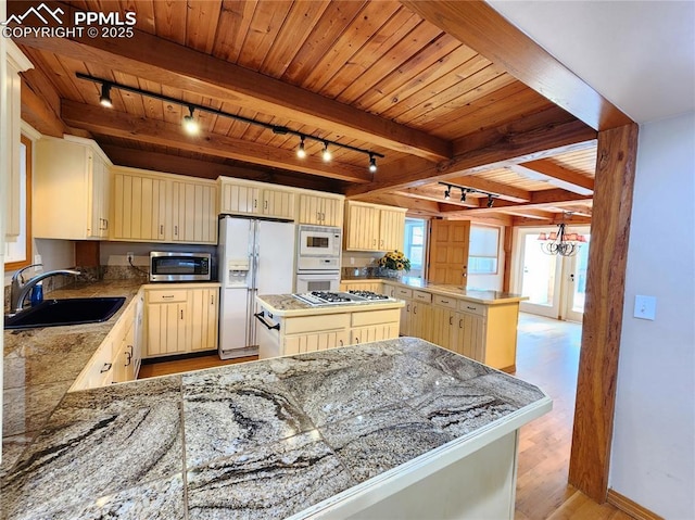 kitchen with white appliances, wooden ceiling, a peninsula, and a sink