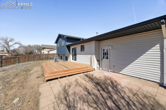 wooden terrace featuring a patio, fence, and central air condition unit