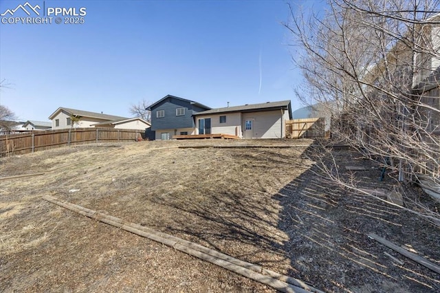 view of yard with fence and a deck