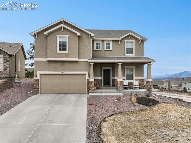 view of front of property with driveway, a porch, an attached garage, stucco siding, and stone siding