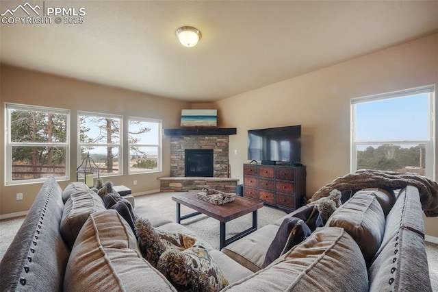 living room with a stone fireplace, baseboards, and light carpet