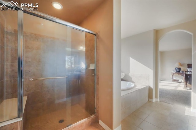 full bath with tile patterned floors, a bath, and a shower stall