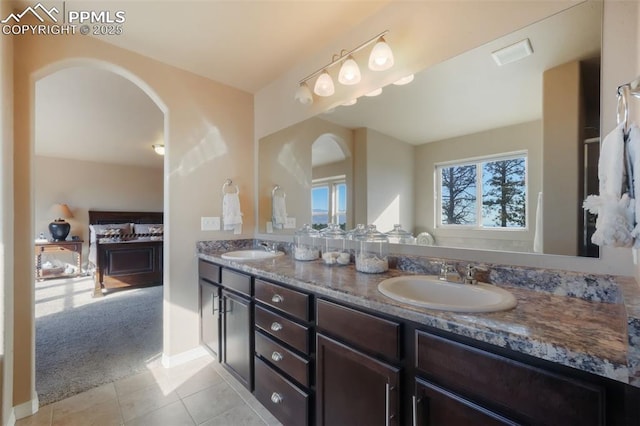 full bath featuring double vanity, tile patterned flooring, visible vents, and a sink