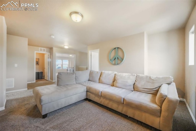 carpeted living area with visible vents and baseboards