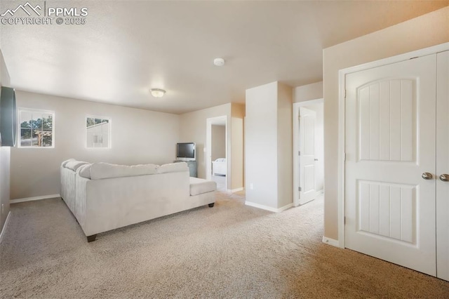 carpeted living room with baseboards