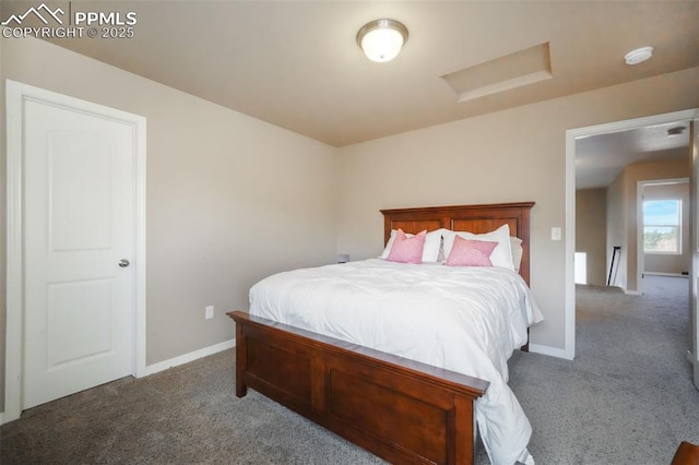 carpeted bedroom featuring attic access and baseboards