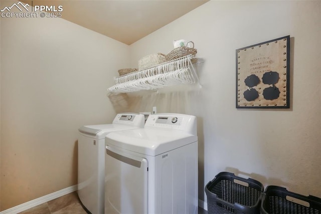 laundry room with washer and dryer, baseboards, laundry area, and tile patterned floors