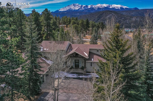 drone / aerial view with a mountain view and a forest view