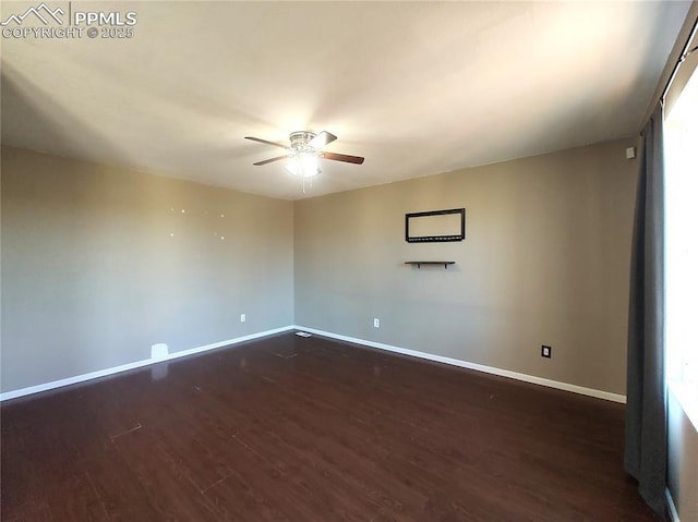 spare room featuring a ceiling fan, baseboards, and wood finished floors