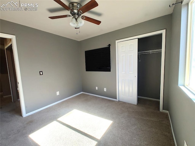 unfurnished bedroom with a ceiling fan, carpet, a closet, and baseboards