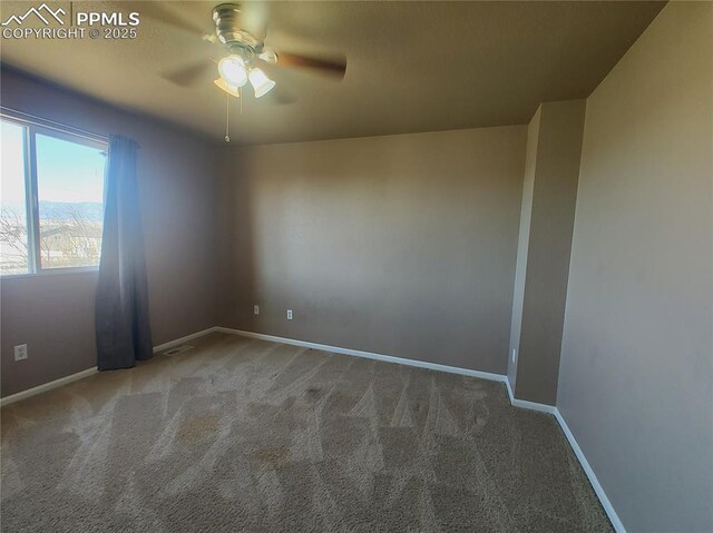 empty room featuring carpet, visible vents, ceiling fan, and baseboards