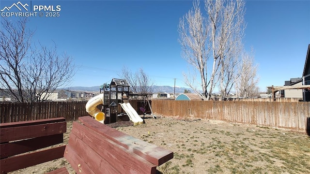 view of yard with a playground and fence