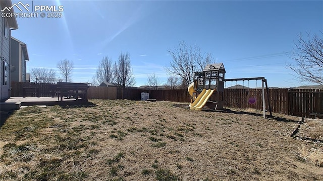 view of yard with a fenced backyard and a playground