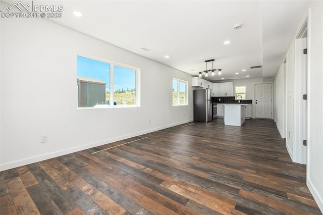 kitchen with white cabinetry, open floor plan, dark wood finished floors, and freestanding refrigerator