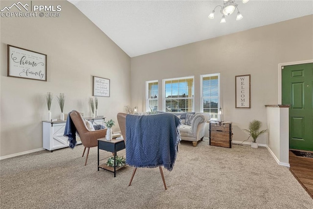 carpeted living room with a textured ceiling, high vaulted ceiling, and baseboards