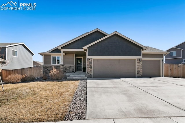 craftsman-style home with a garage, concrete driveway, and fence