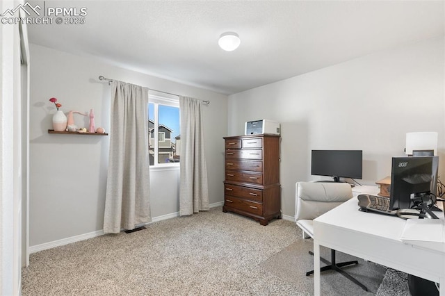 carpeted office featuring baseboards