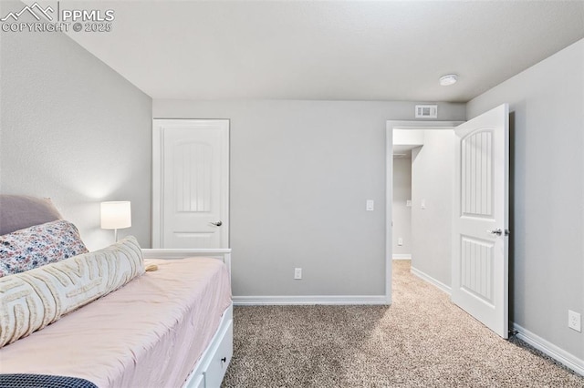 carpeted bedroom with baseboards and visible vents