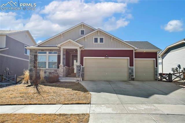 craftsman inspired home featuring a garage, driveway, fence, and board and batten siding