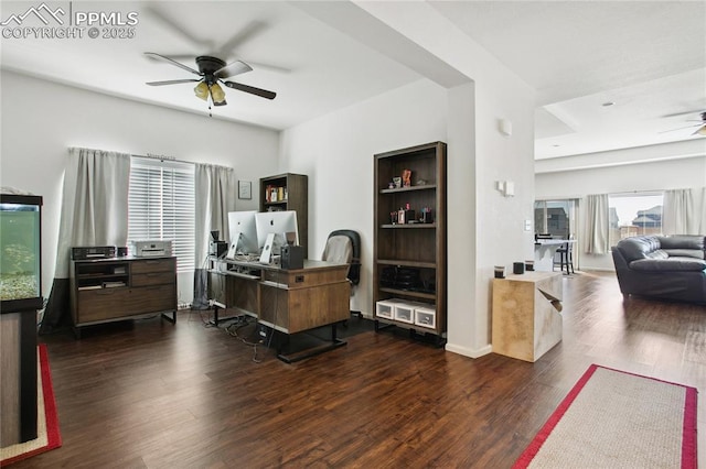 office area with dark wood-style floors, a ceiling fan, and baseboards